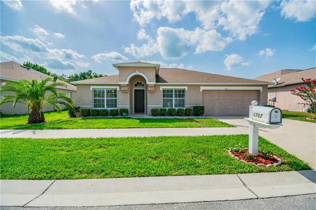 a front view of house with yard and green space