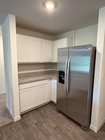 a kitchen with cabinets and stainless steel appliances