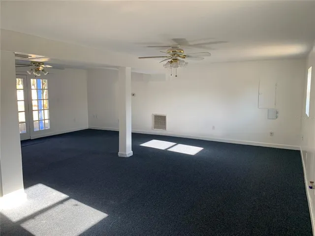 a view of a livingroom with a ceiling fan and window