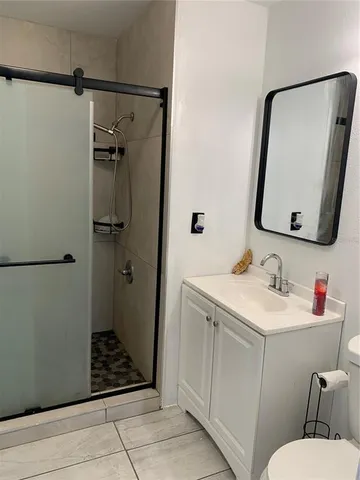 a bathroom with a sink a toilet and mirror