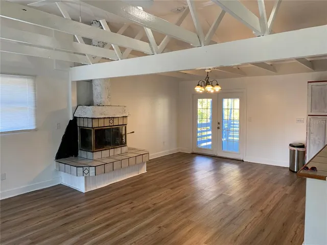 a living room with hard wood floors and a fireplace