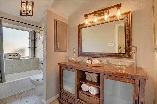 a bathroom with a toilet a sink and a mirror