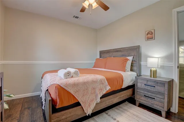 a bedroom with a bed and a chandelier