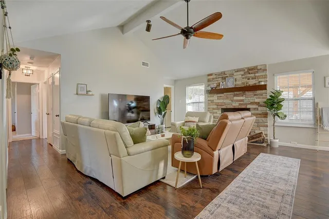 a living room with furniture wooden floor and a fireplace