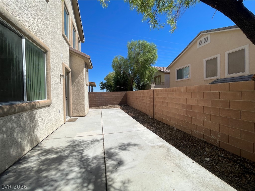 11049 Zarod Road Las Vegas, NV 89135 - Photo 16 of 17 A spacious concrete patio sits securely within a private backyard bordered by a block wall.