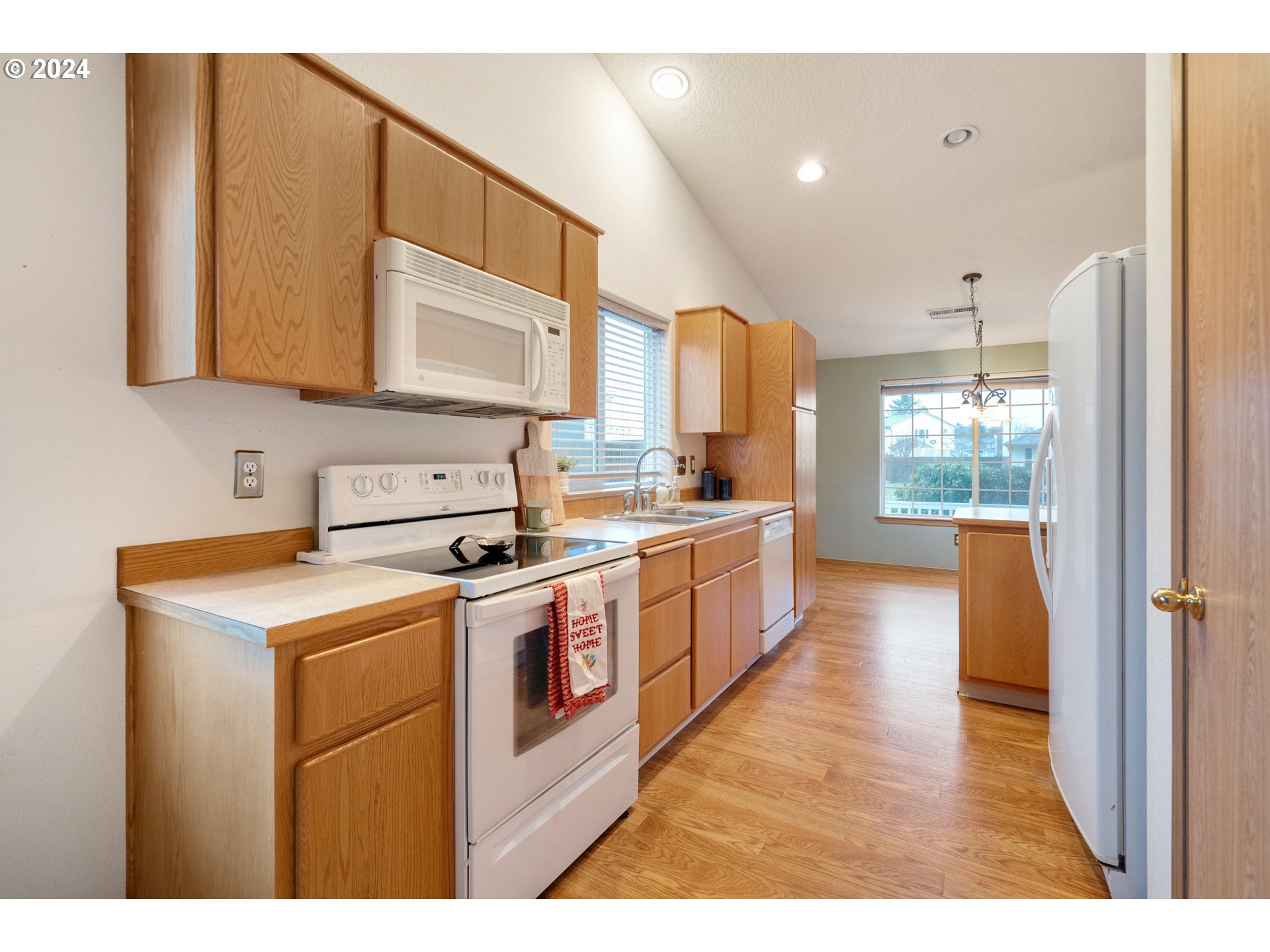 13509 Northeast 77th Street Vancouver, WA 98682 - Photo 13 of 29 a kitchen with a stove a sink and a refrigerator