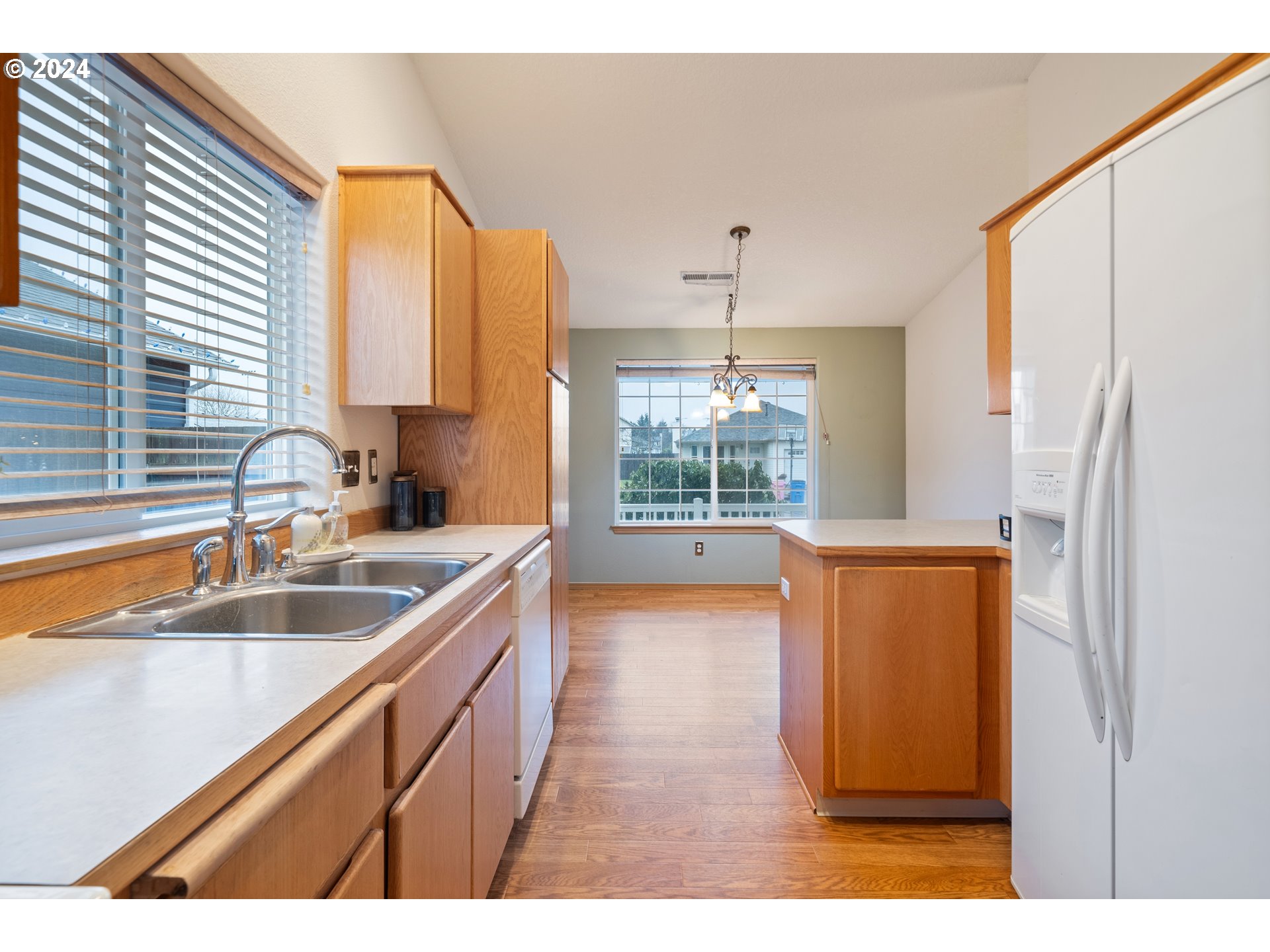 13509 Northeast 77th Street Vancouver, WA 98682 - Photo 14 of 29 a kitchen with a sink a refrigerator and window