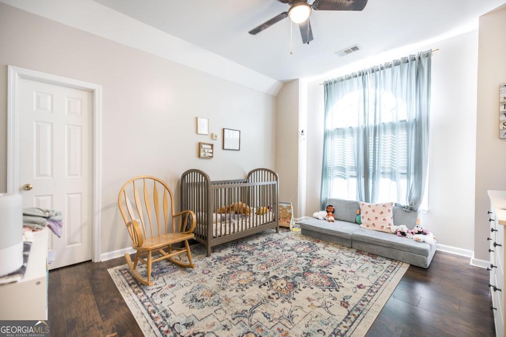 128 Springwood Court Macon, GA 31210 - Photo 13 of 22 a bed room with a bed and a chair