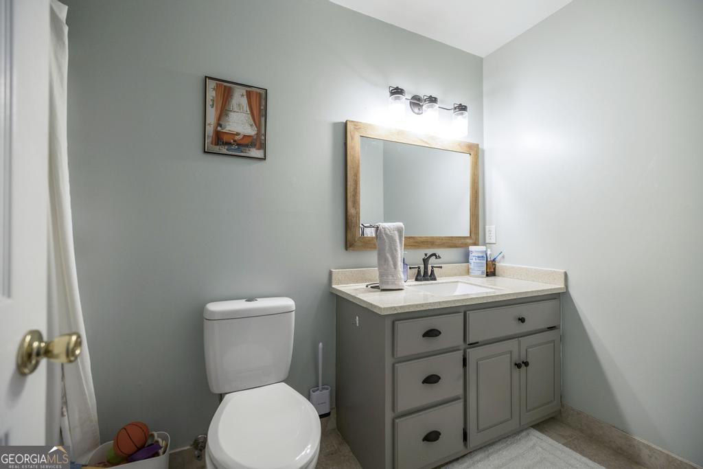 128 Springwood Court Macon, GA 31210 - Photo 15 of 22 a bathroom with a toilet a sink and mirror
