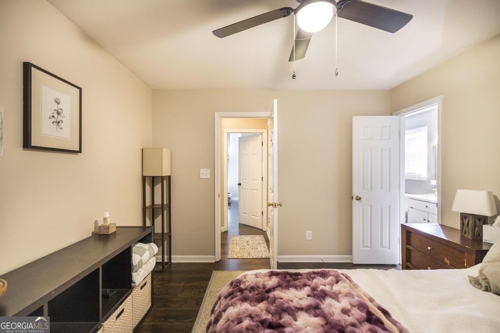 128 Springwood Court Macon, GA 31210 - Photo 16 of 22 a bedroom with a bed and a chandelier