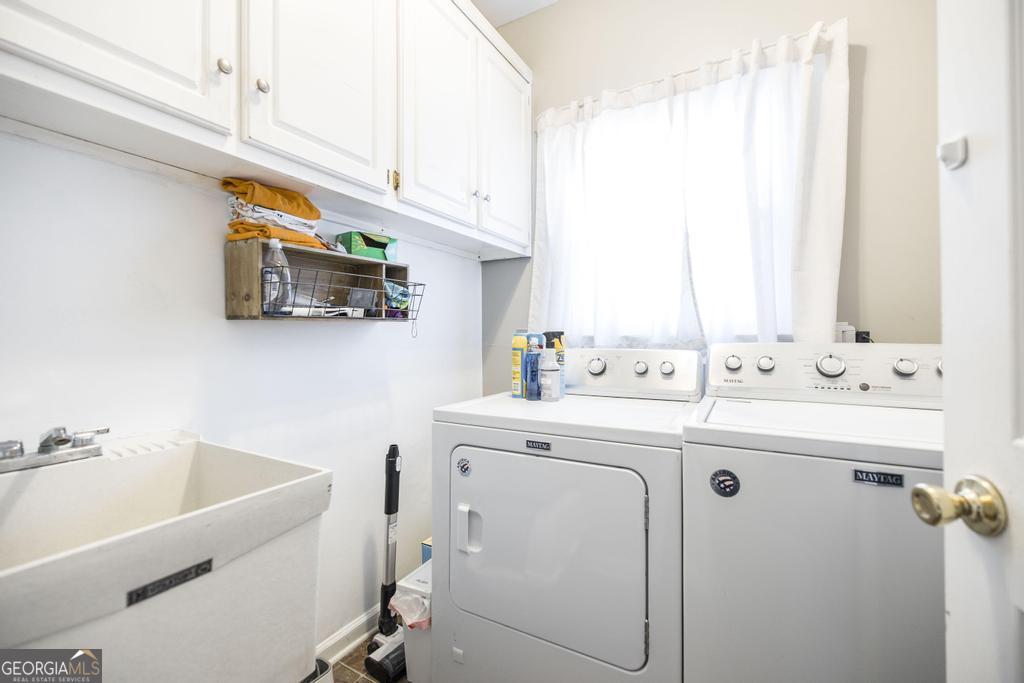 128 Springwood Court Macon, GA 31210 - Photo 19 of 22 a utility room with cabinets washer and dryer