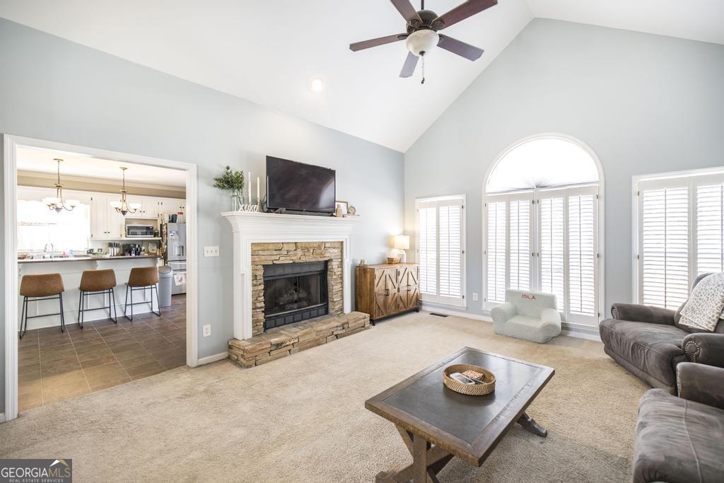 128 Springwood Court Macon, GA 31210 - Photo 2 of 22 a living room with furniture a fireplace and a flat screen tv