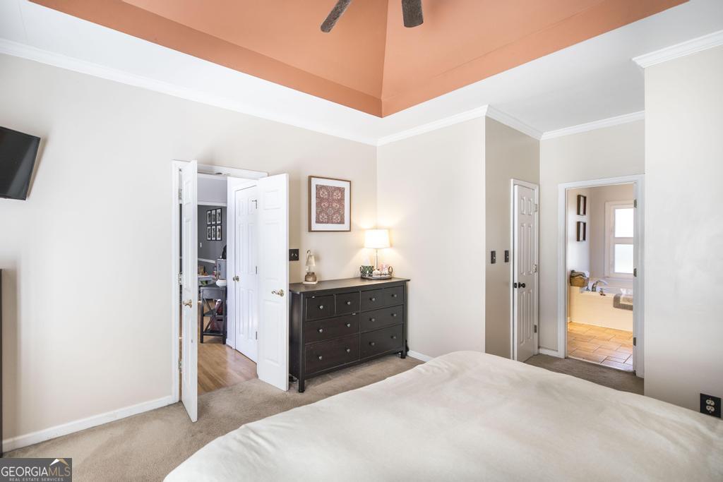 128 Springwood Court Macon, GA 31210 - Photo 9 of 22 a spacious bedroom with a bed and a chandelier