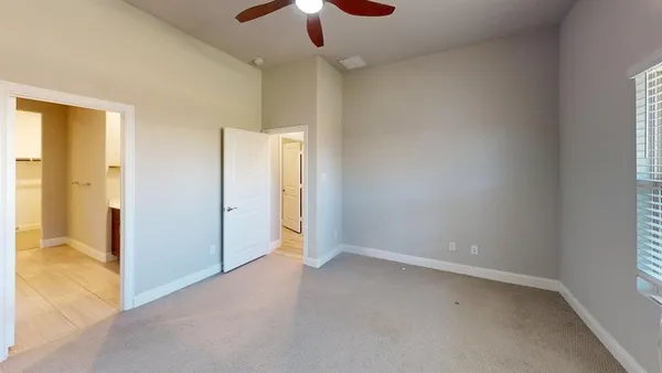 an empty room with a empty space and a ceiling fan