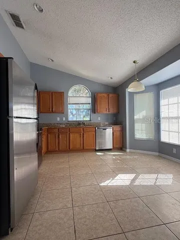a view of a kitchen with a sink and a window
