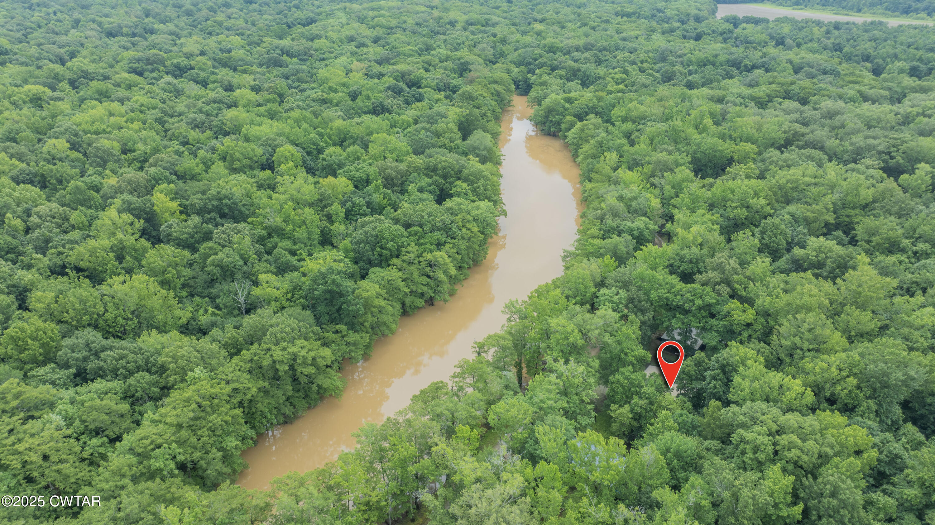 525 Wesley Lake Road Brownsville, TN 38012 - Photo 18 of 21 a view of a lake with a house and a yard