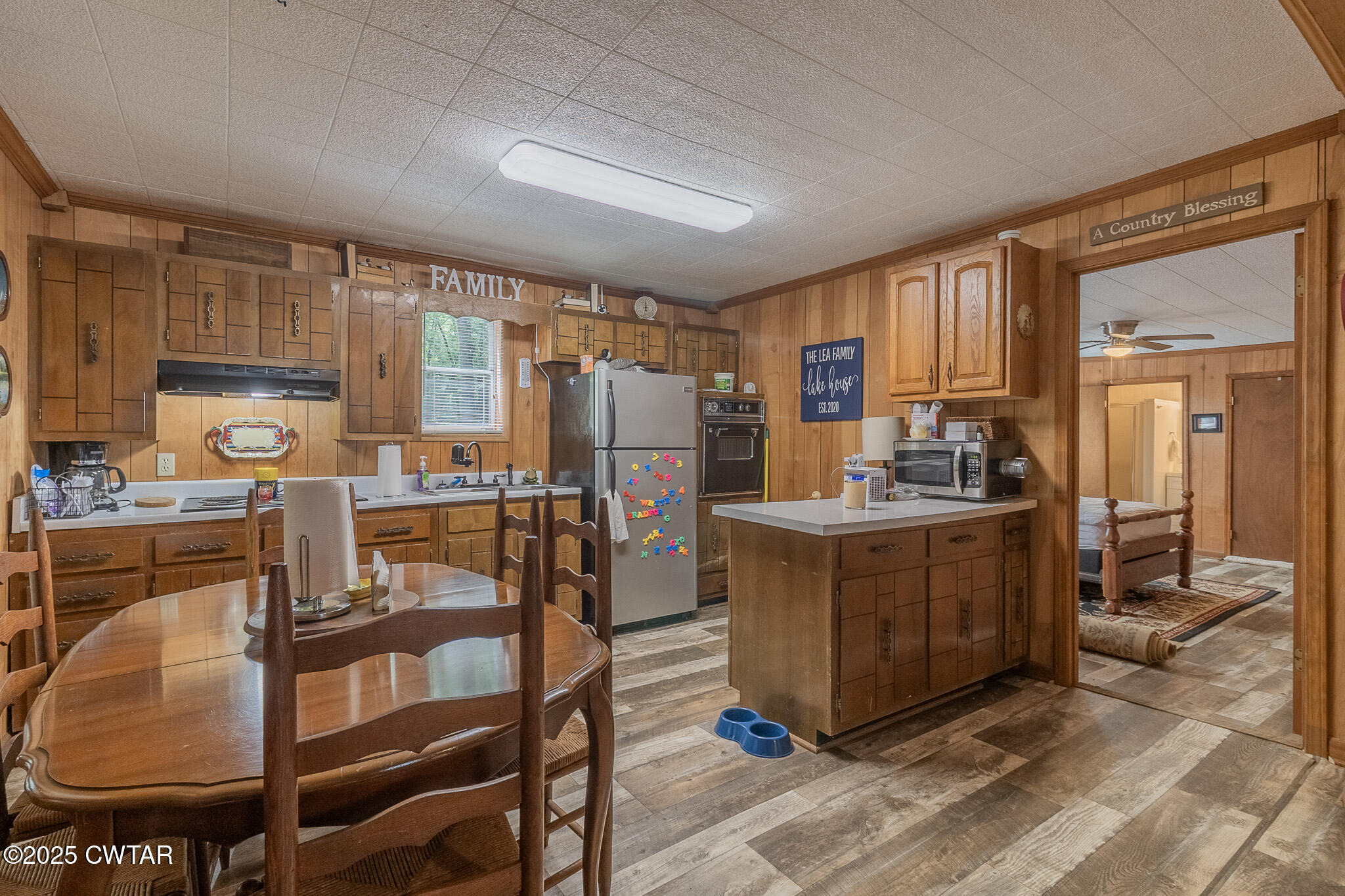 525 Wesley Lake Road Brownsville, TN 38012 - Photo 8 of 21 a kitchen with a refrigerator a stove a sink dishwasher and wooden cabinets with wooden floor