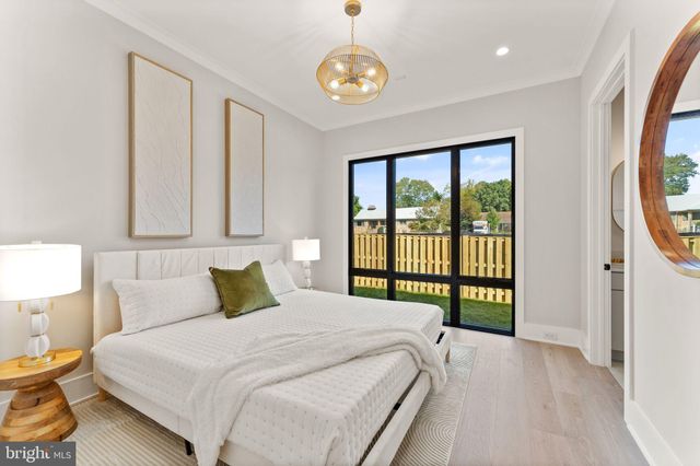 a view of a livingroom with a flesh screen tv and bedroom view