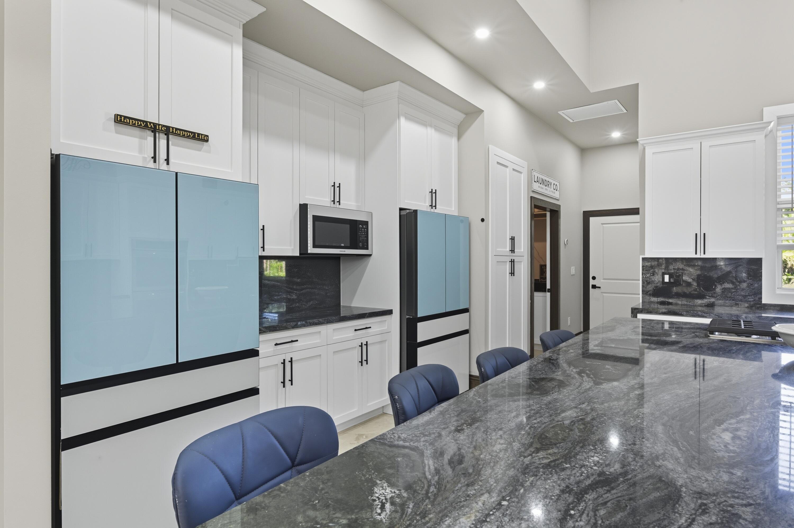 8350 Whispering Oak Way West Palm Beach, FL 33411 - Photo 14 of 51 a kitchen with stainless steel appliances a refrigerator and a stove top oven