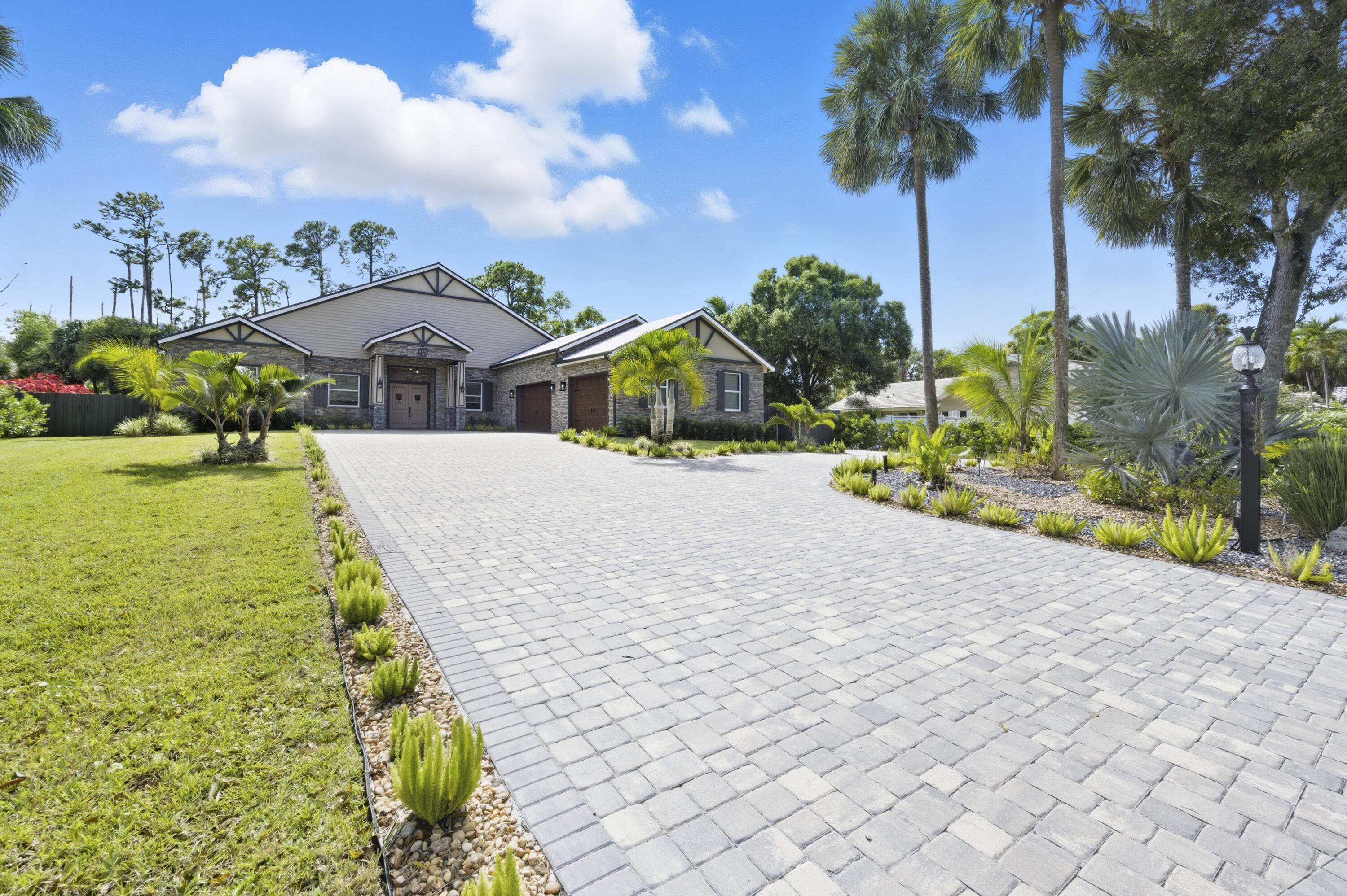 8350 Whispering Oak Way West Palm Beach, FL 33411 - Photo 2 of 51 a front view of a house with garden