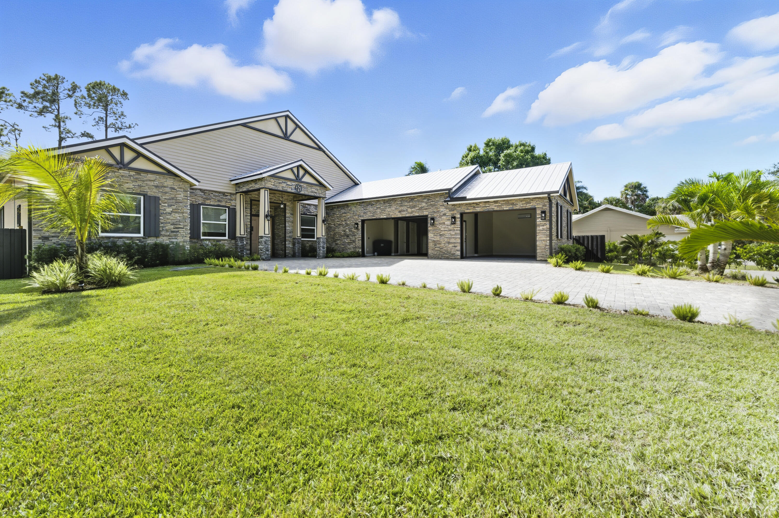 8350 Whispering Oak Way West Palm Beach, FL 33411 - Photo 3 of 51 a front view of a house with a big yard and potted plants