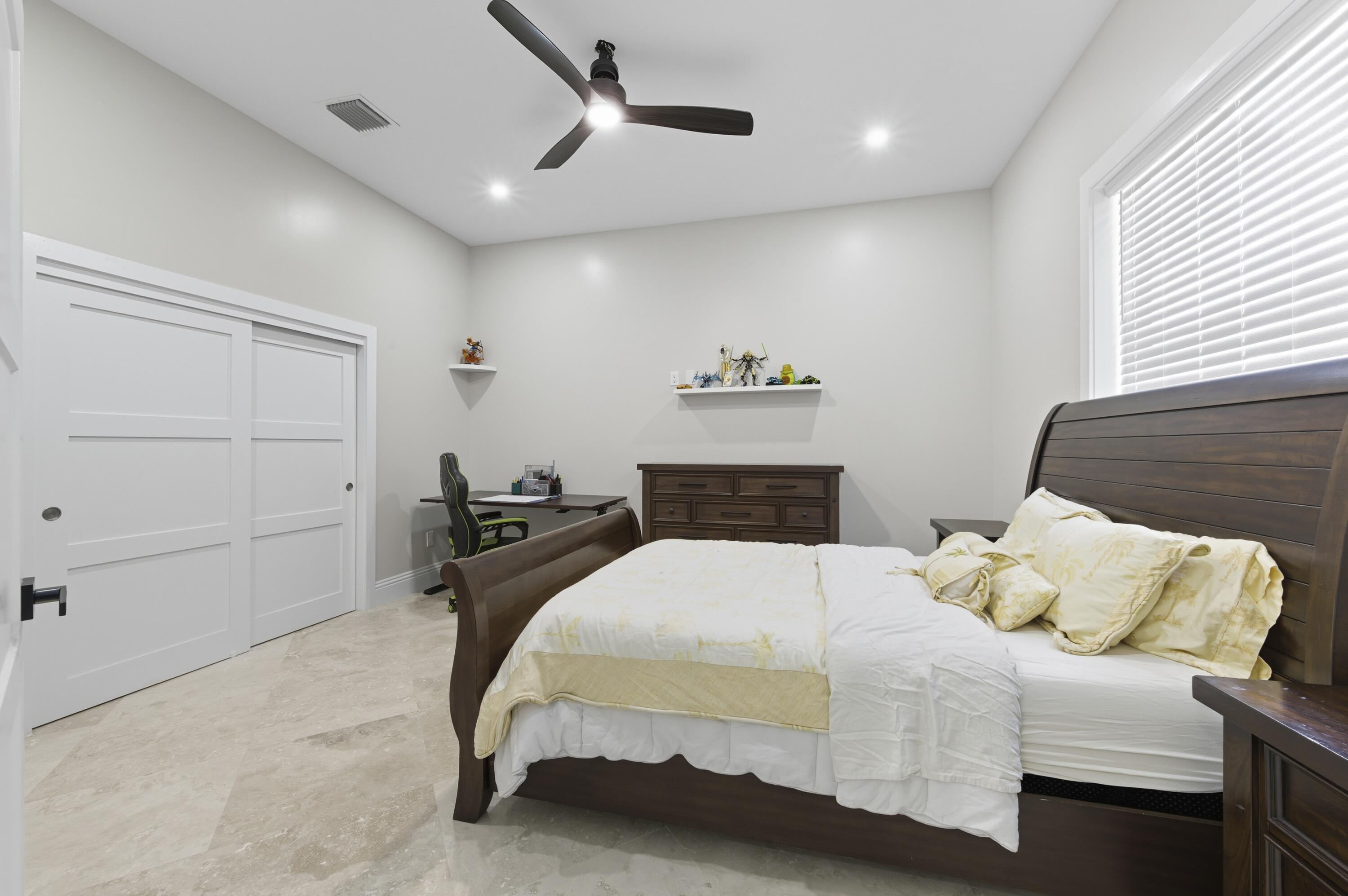 8350 Whispering Oak Way West Palm Beach, FL 33411 - Photo 32 of 51 a bedroom with a bed and a painting on the wall