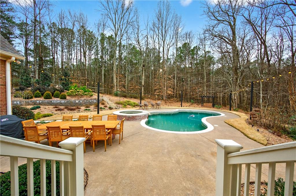121 Laurel Ridge Drive Alpharetta, GA 30004 - Photo 12 of 14 a view of a swimming pool with a patio and a yard