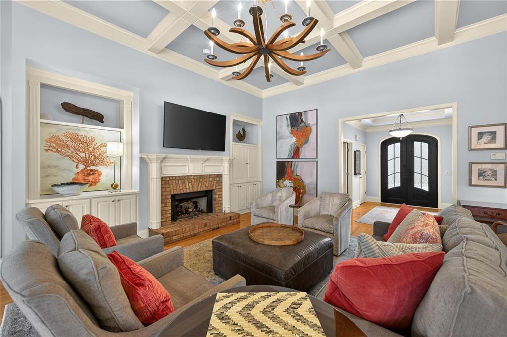 121 Laurel Ridge Drive Alpharetta, GA 30004 - Photo 3 of 14 a living room with furniture a flat screen tv and a fireplace