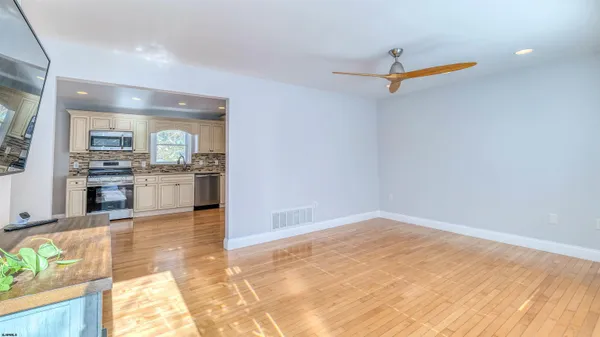 a view of a kitchen with a sink and cabinets