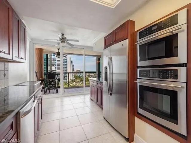 a kitchen with granite countertop a refrigerator oven and a sink