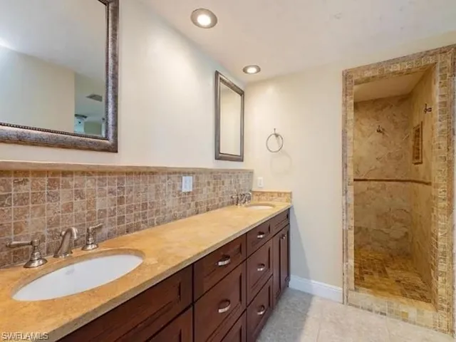 a bathroom with a granite countertop sink mirror and double