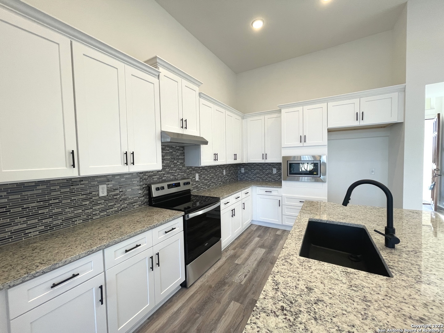 101 Daniel Jackson Blanco, TX 78606 - Photo 4 of 11 a kitchen with granite countertop a stove a sink and a granite counter tops