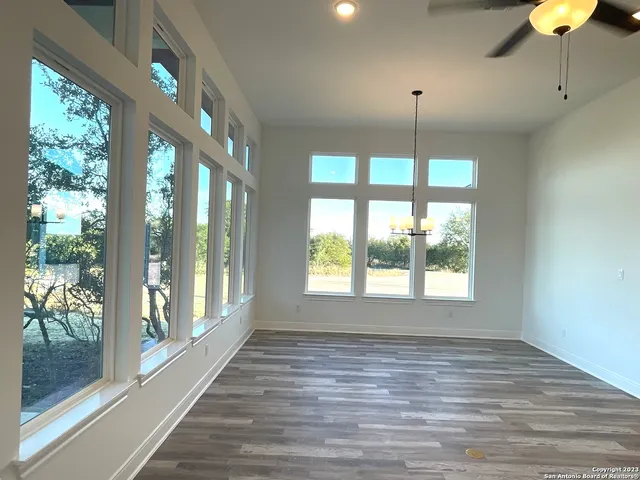a bathroom with a large window and chandelier