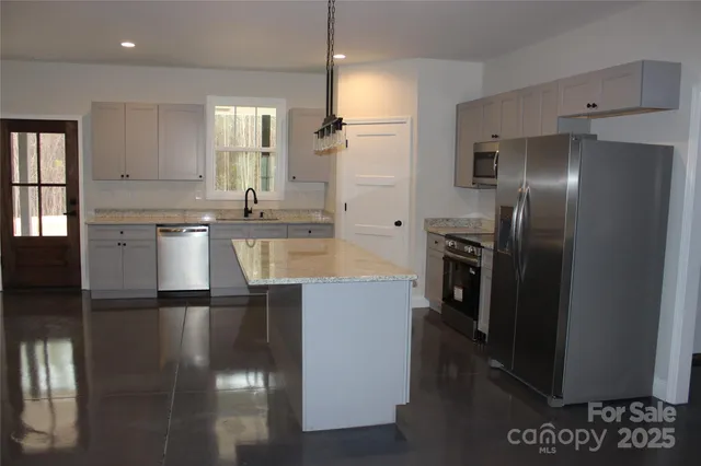 a kitchen with a refrigerator and a sink