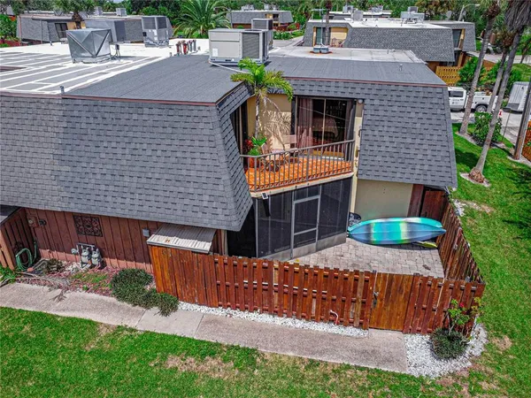 a aerial view of a house with a yard and potted plants