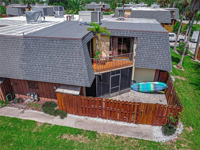 a aerial view of a house with a yard and potted plants