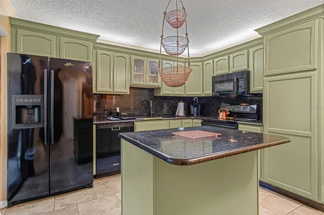 a kitchen with stainless steel appliances granite countertop a sink and cabinets