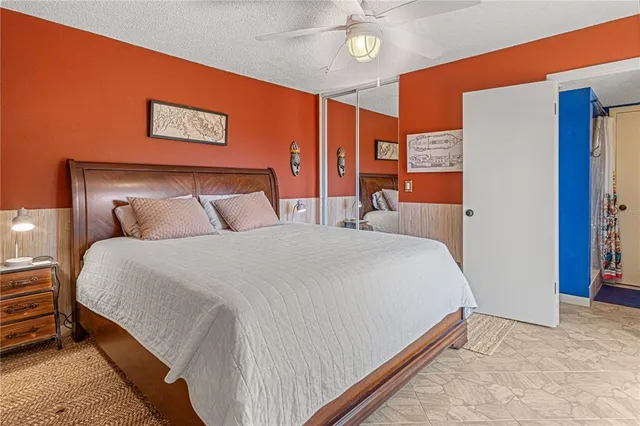 a bedroom with a large bed and a large window