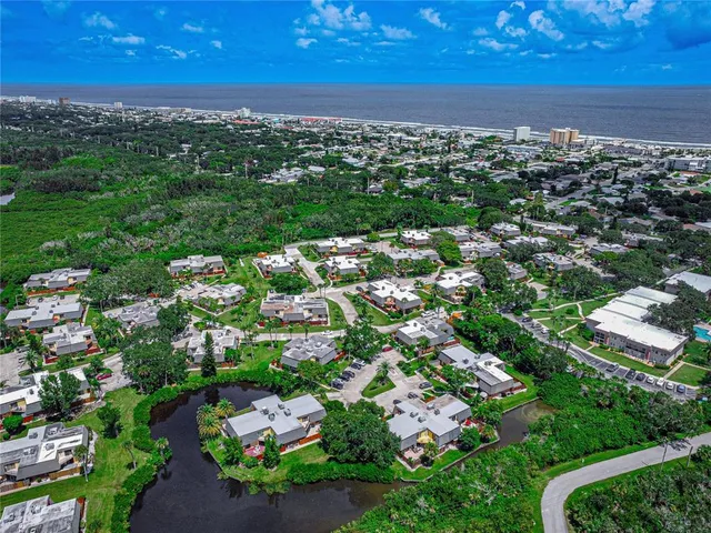 an aerial view of residential houses with outdoor space and street view