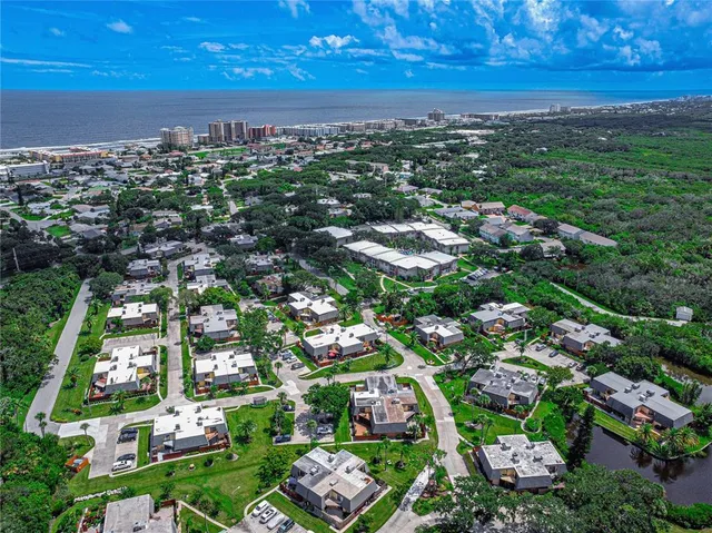 an aerial view of multiple houses with yard