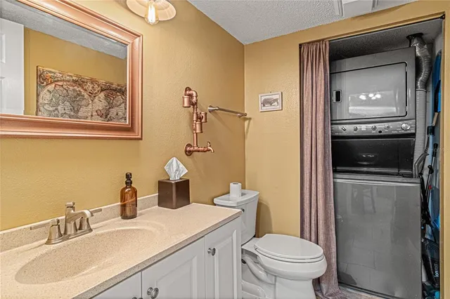 a kitchen with stainless steel appliances granite countertop a stove top oven a sink and cabinets