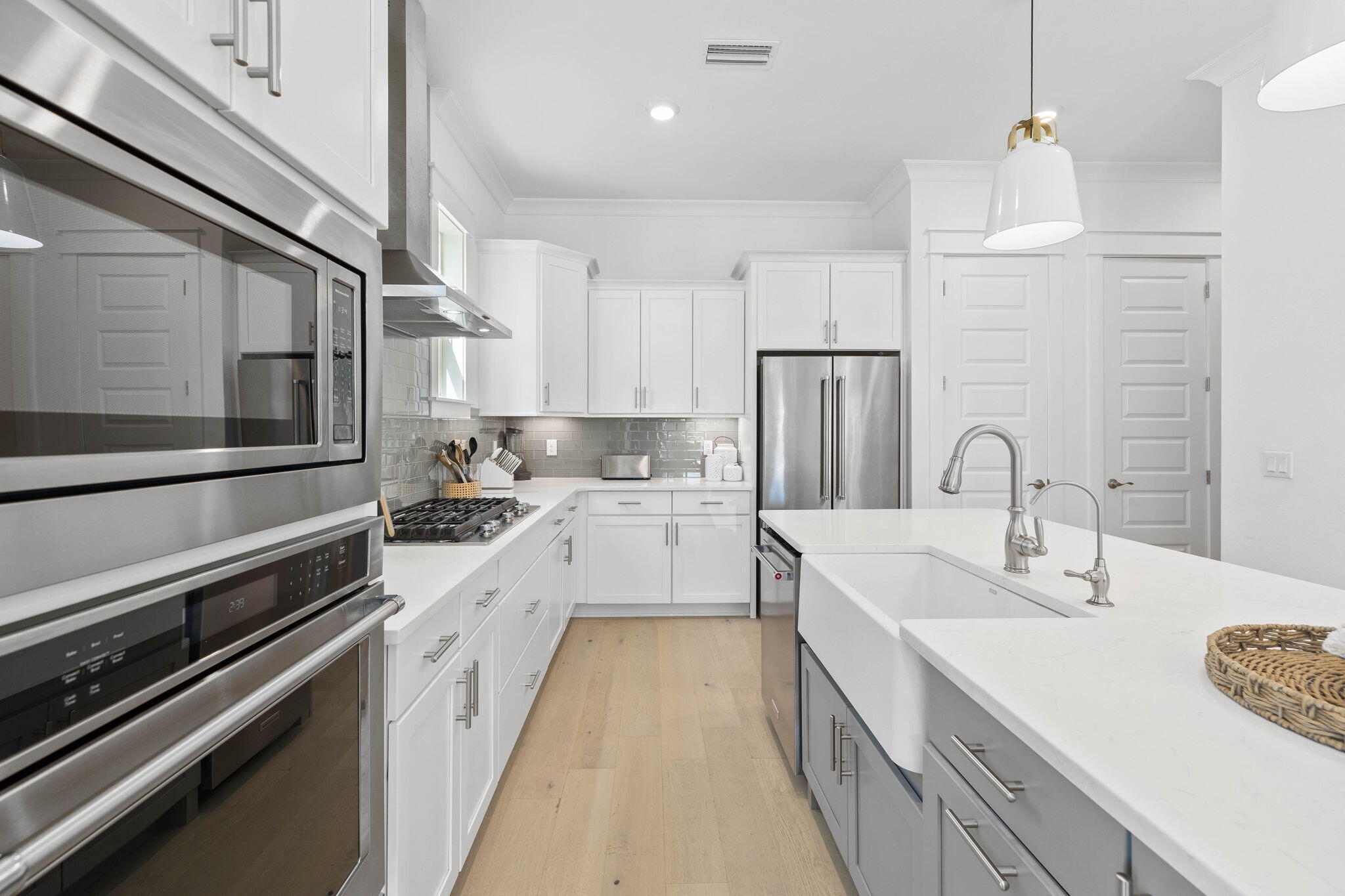 80 Wharf Ln Inlet Beach, Unit B Inlet Beach, FL 32461 - Photo 10 of 43 a large kitchen with stainless steel appliances sink a stove and white cabinets with wooden floor