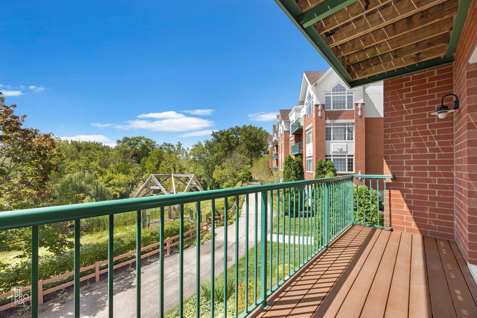 640 McHenry Road, Unit 208 Wheeling, IL 60090 - Photo 13 of 21 a view of a balcony with wooden floor & fence