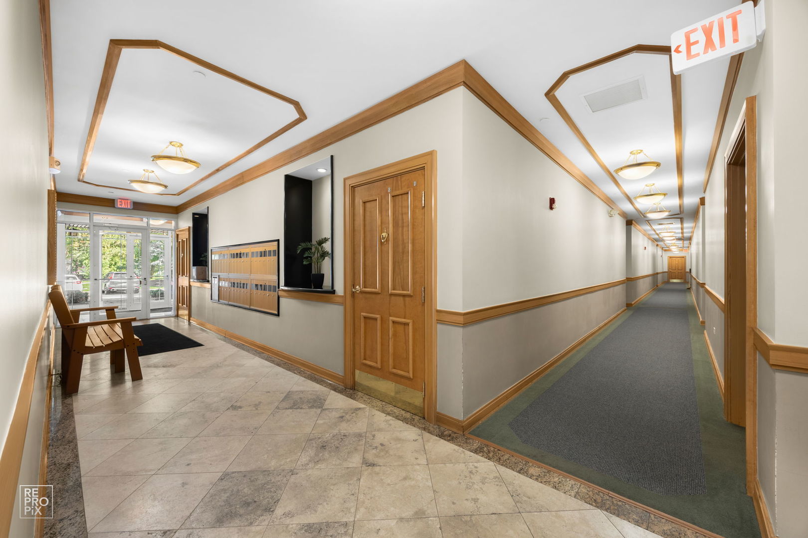 640 McHenry Road, Unit 208 Wheeling, IL 60090 - Photo 2 of 21 a view of a hallway with furniture and front door