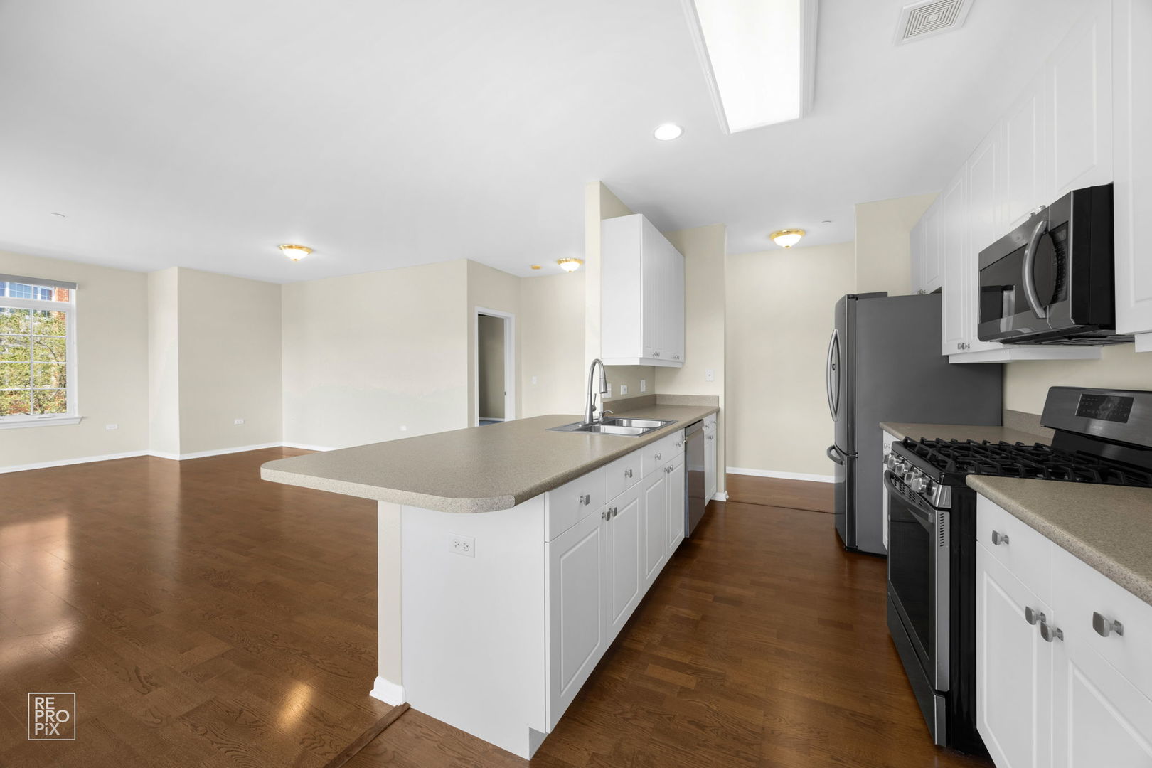 640 McHenry Road, Unit 208 Wheeling, IL 60090 - Photo 5 of 21 a large kitchen with stainless steel appliances granite countertop a stove a sink and a refrigerator