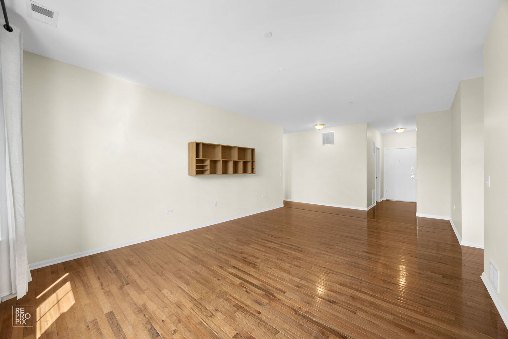 640 McHenry Road, Unit 208 Wheeling, IL 60090 - Photo 6 of 21 a view of an empty room and wooden floor