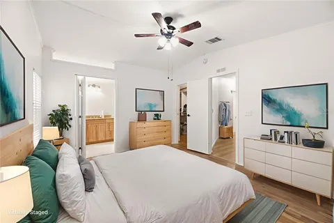 a view of a room with wooden floor and ceiling fan
