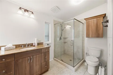 a bathroom with a double vanity sink mirror and shower