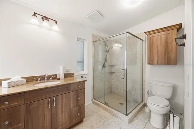 a bathroom with a double vanity sink mirror and shower