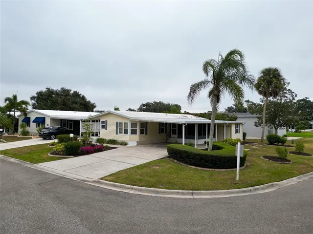 a front view of a house with a garden and trees
